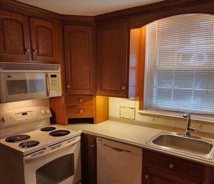 Post restoration photo - ceiling replaced and painted, counter tops installed and cabinets installed and refinished. 