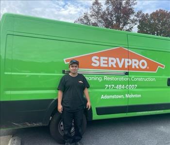 SERVPRO man stands in front of SERVPRO trailer