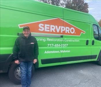 SERVPRO man stands in front of SERVPRO van