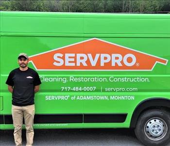 Employee Doug Castellon standing next to the green SERVPRO Promaster Va