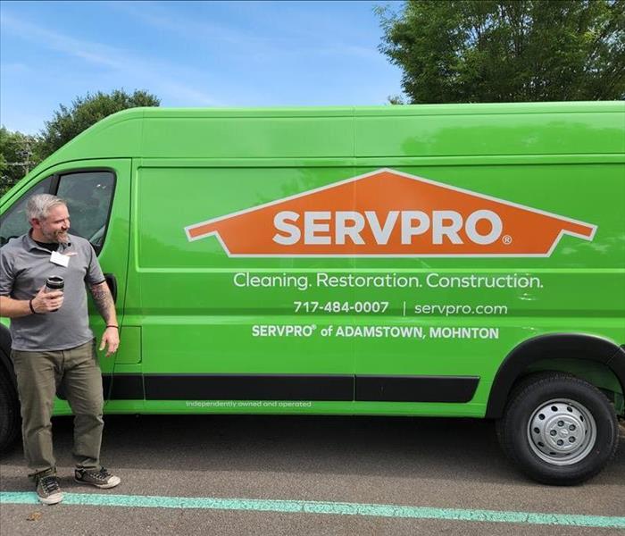 New Owner Kevin Paul standing next to new SERVPRO van.